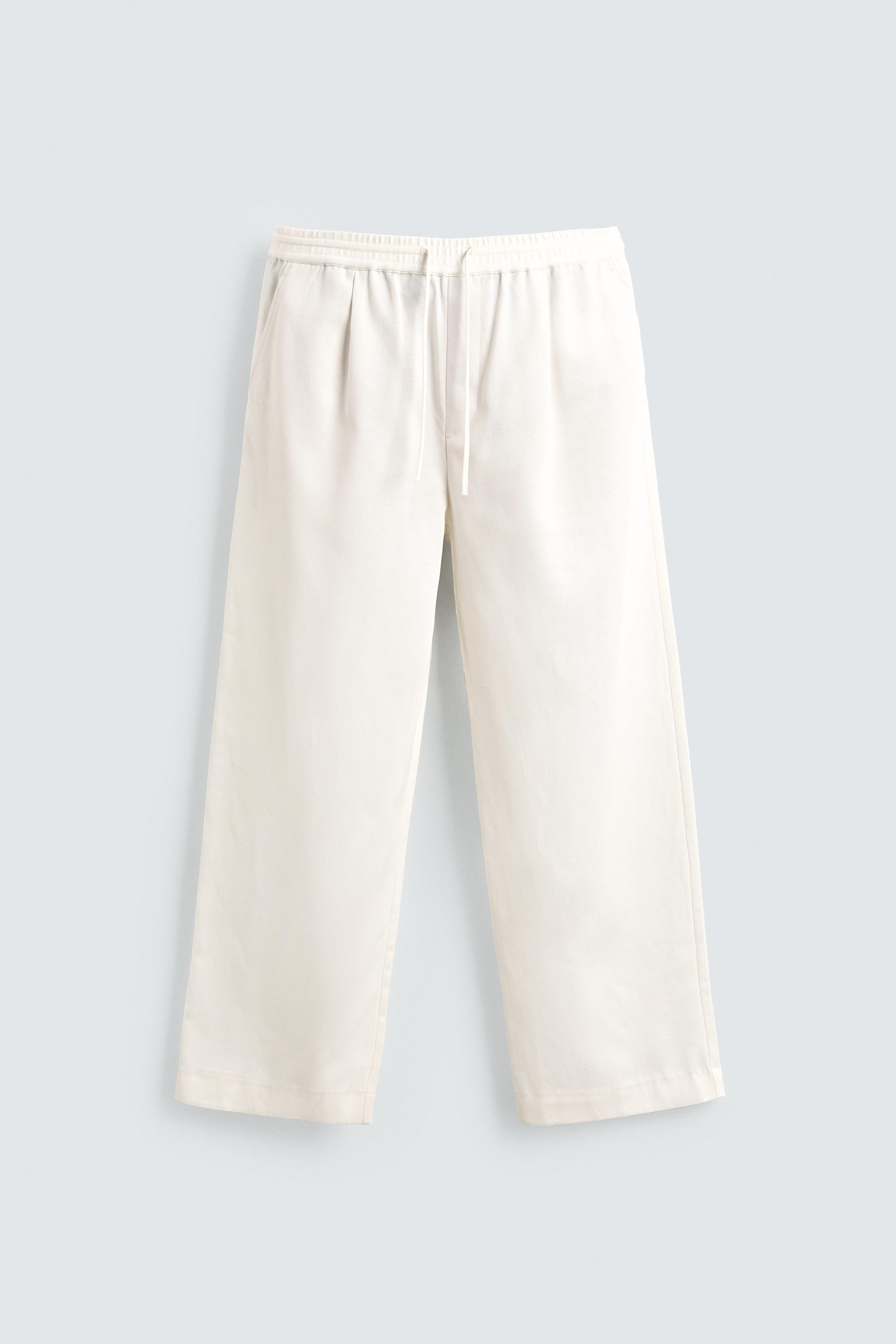 TEXTURED PLEATED PANTS